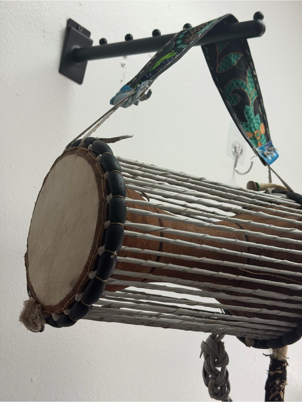 Hand Crafted drum with black rims and green patterned strap